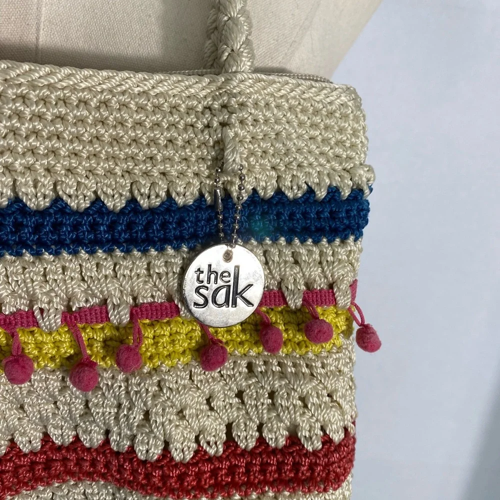 The Sak crocheted striped shoulder bag with pink pom-poms Casual Classics